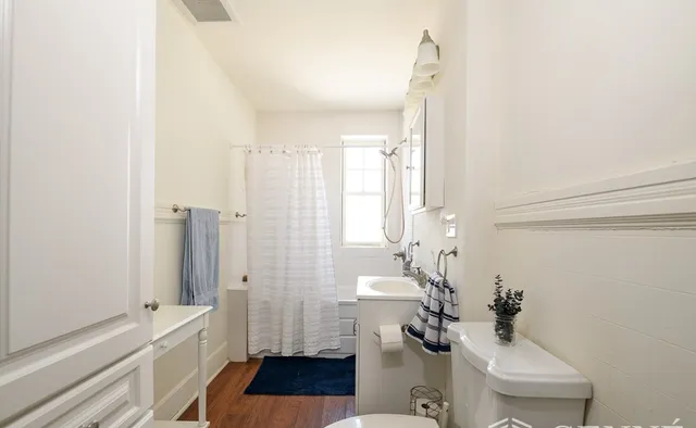 a bathroom with a sink a toilet and a shower