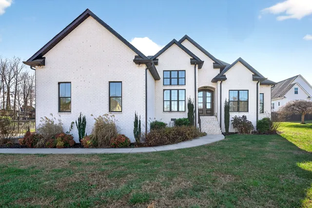 a front view of a house with garden