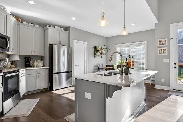 a kitchen with refrigerator and cabinets