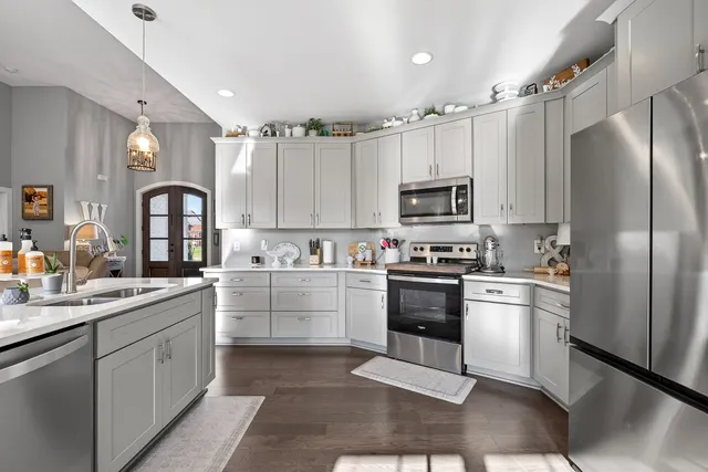 a kitchen with a white cabinets and stainless steel appliances
