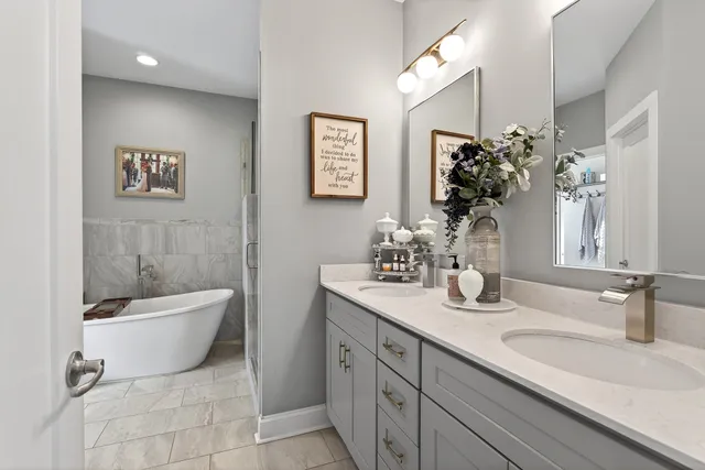 a bathroom with a granite countertop sink a toilet a mirror and bathtub