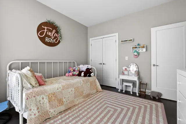 a bedroom with a bed and a table in it