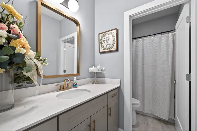 a bathroom with a sink vanity granite and a mirror