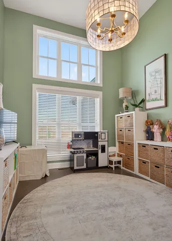 a living room with furniture and a chandelier