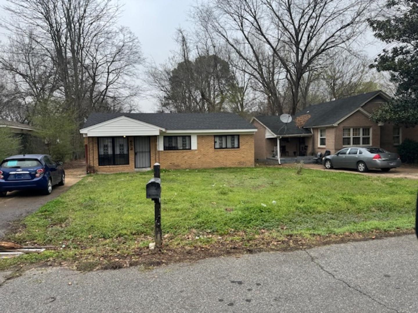 452 Delta Road Memphis, TN 38109 - Photo 4 of 6 a front view of a house with a yard and trees