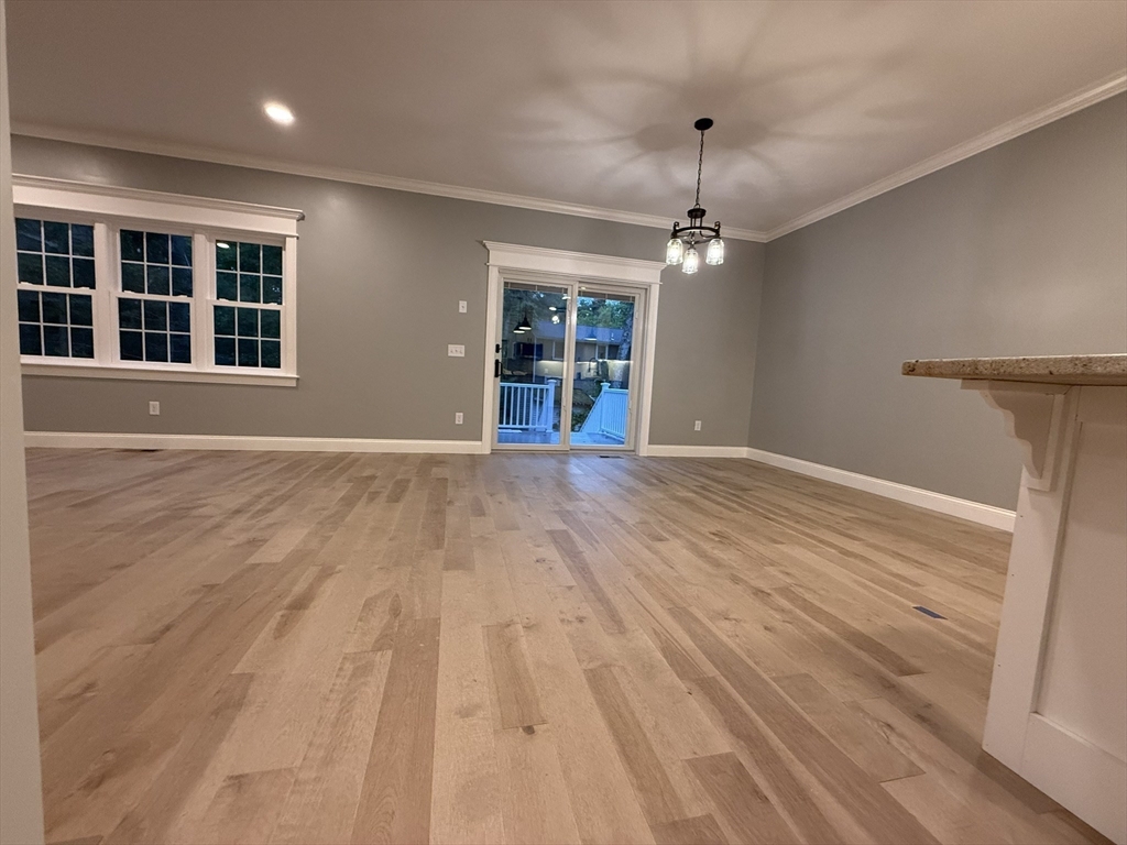 24 Cooper Road Webster, MA 01570 - Photo 11 of 42 a view of an empty room with a window and wooden floor