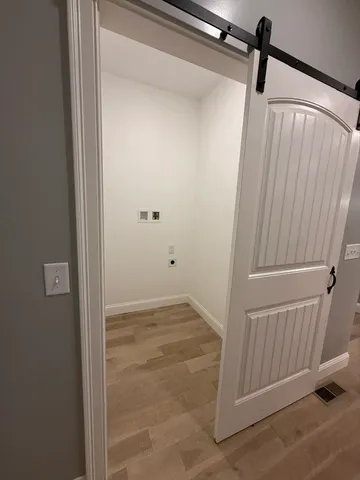 a view of hallway with wooden floor