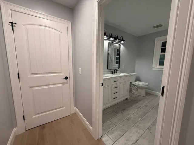 a view of hallway with wooden floor