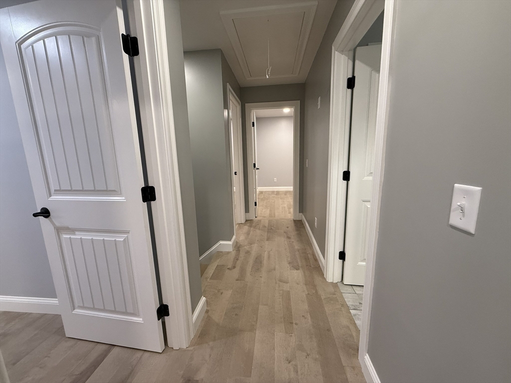 24 Cooper Road Webster, MA 01570 - Photo 31 of 42 a view of a hallway with wooden floor and staircase