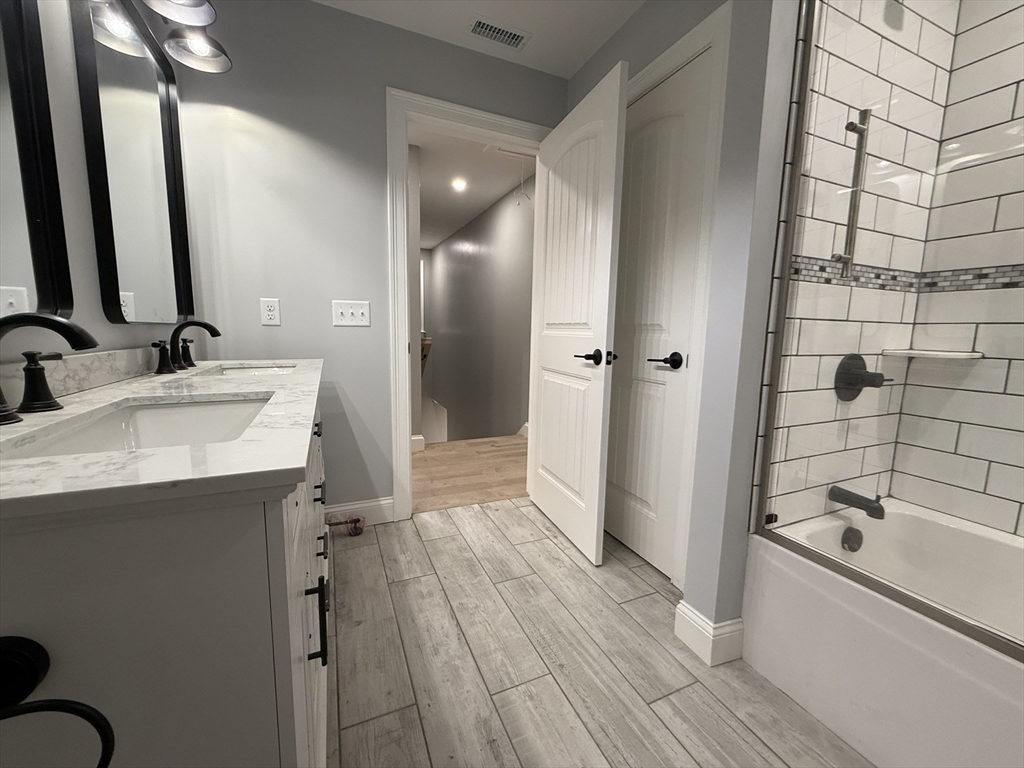 24 Cooper Road Webster, MA 01570 - Photo 38 of 42 a bathroom with a sink a mirror and a bathtub