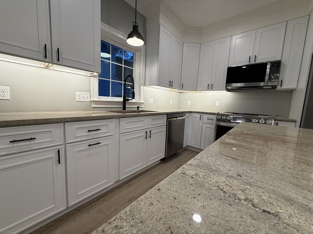 24 Cooper Road Webster, MA 01570 - Photo 5 of 42 a kitchen with a sink stove and microwave