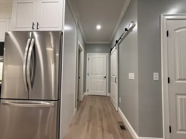 a view of a refrigerator in kitchen and wooden floor