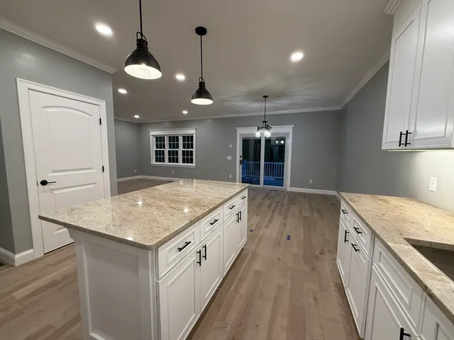 a view of kitchen with cabinets and wooden floor