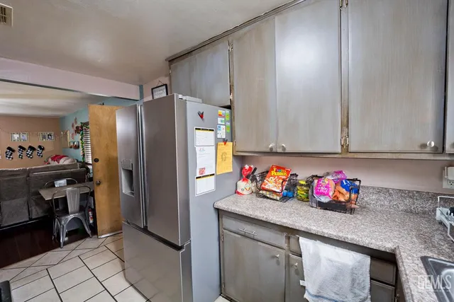 a bathroom with a granite countertop sink a mirror and a shower curtain