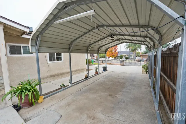 a living room with furniture flowers and a flat screen tv