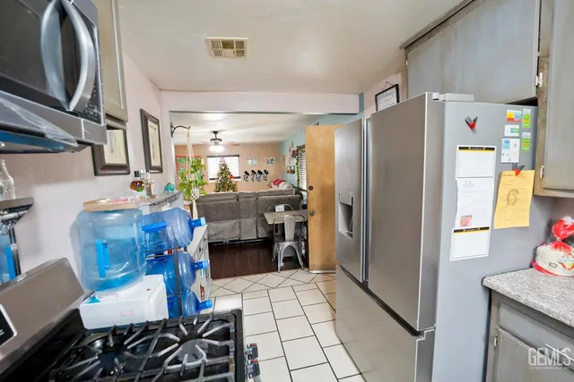 a kitchen with stainless steel appliances a refrigerator and a counter