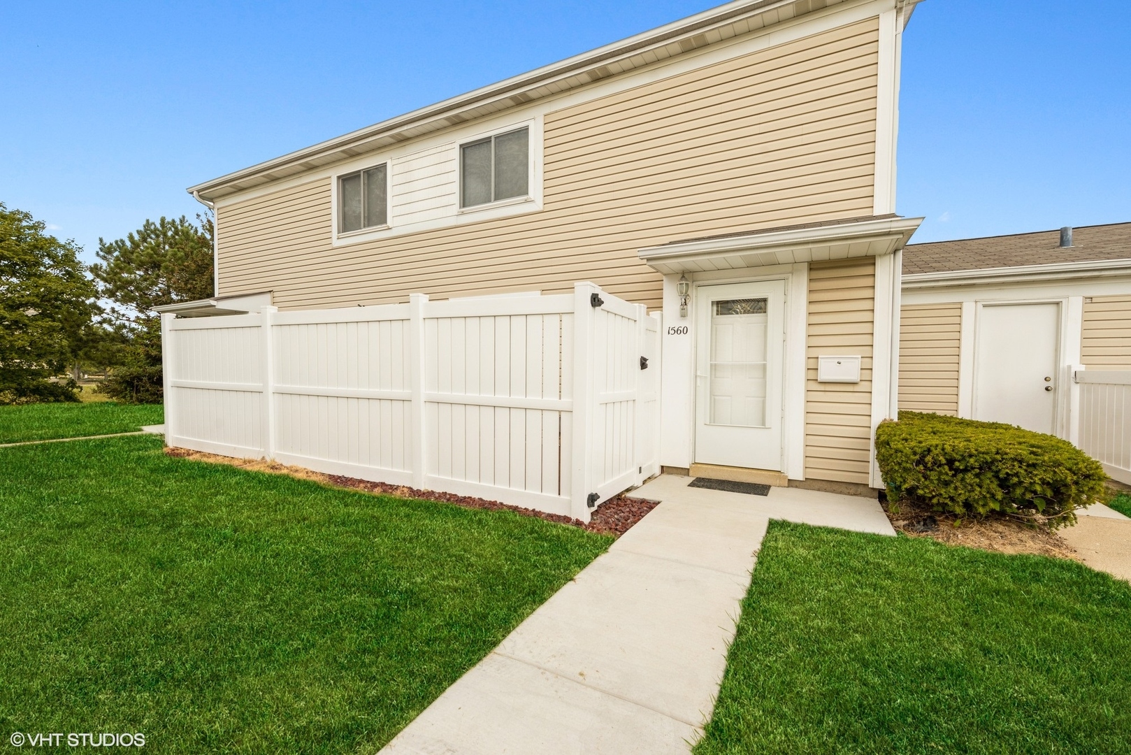 1560 Cornell Circle, Unit 31A Hoffman Estates, IL 60169 - Photo 1 of 12 a backyard of a house with potted plants and a garden