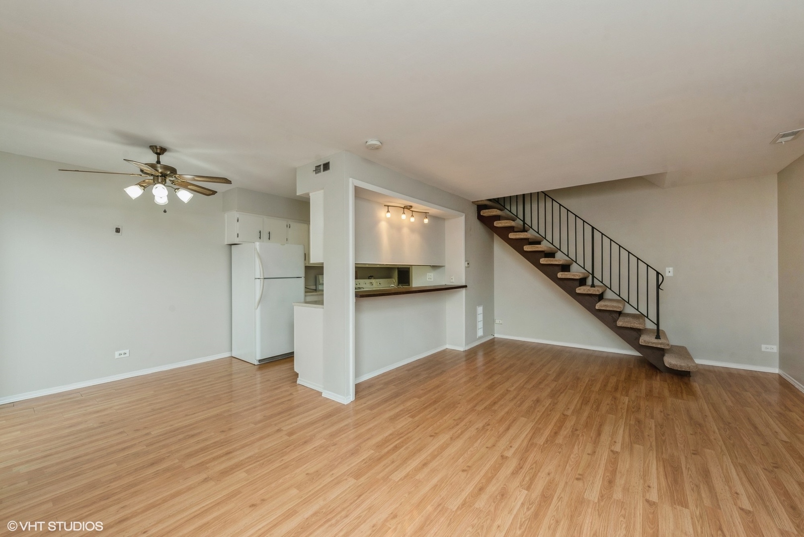 1560 Cornell Circle, Unit 31A Hoffman Estates, IL 60169 - Photo 2 of 12 a view of empty room with wooden floor and fan