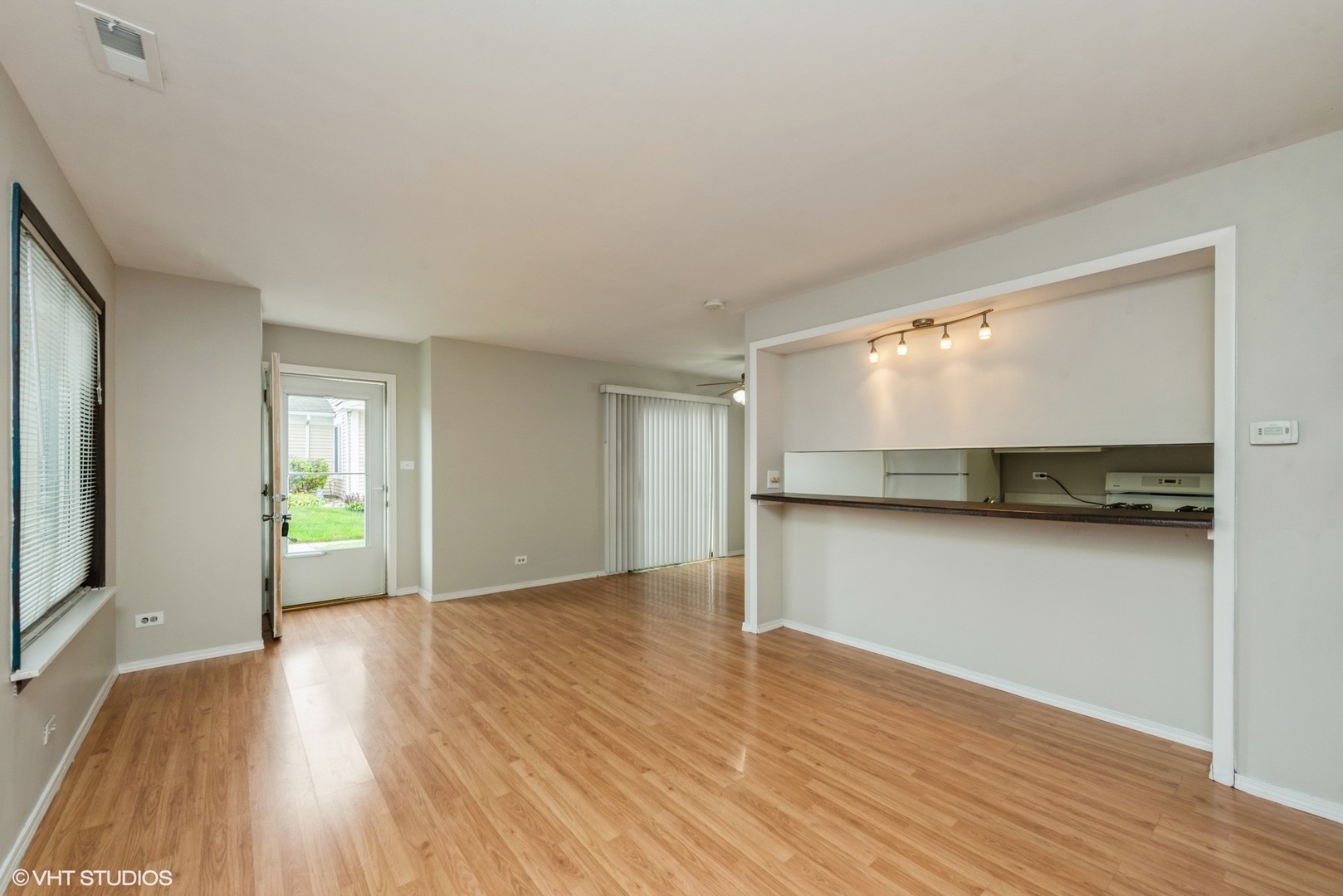 1560 Cornell Circle, Unit 31A Hoffman Estates, IL 60169 - Photo 3 of 12 a view of an empty room with wooden floor and a window