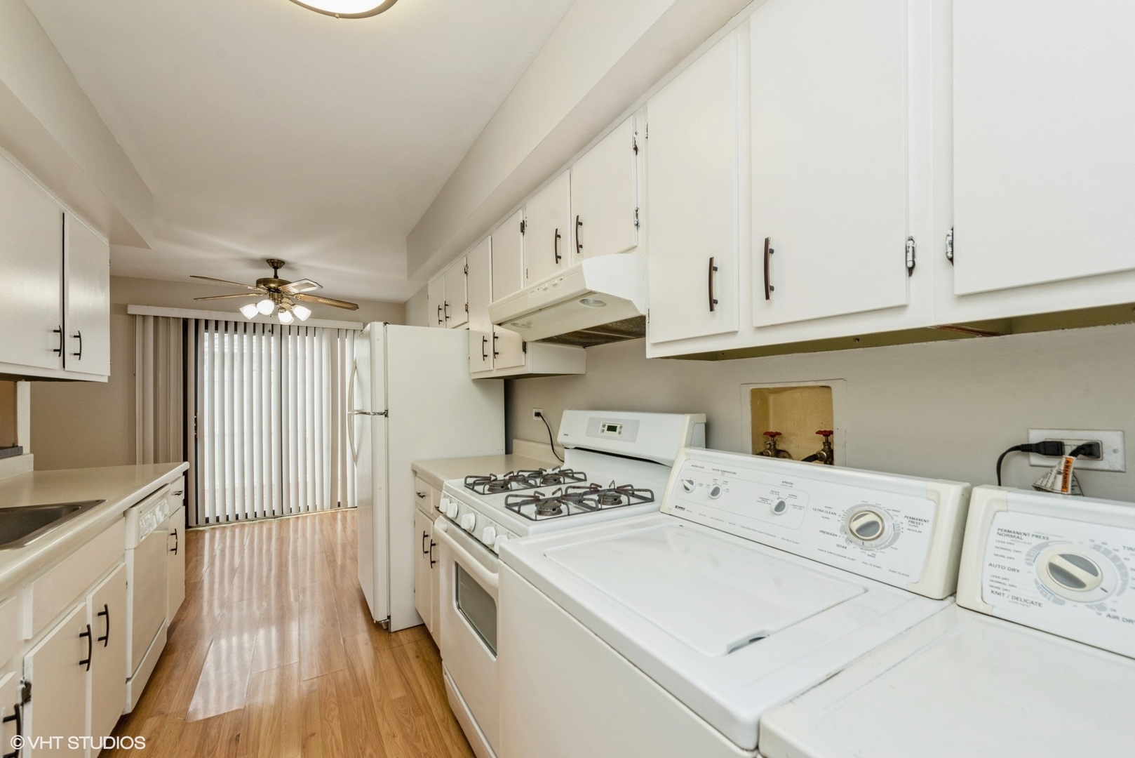1560 Cornell Circle, Unit 31A Hoffman Estates, IL 60169 - Photo 5 of 12 a kitchen with cabinets a sink and white appliances