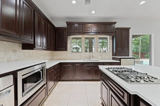 a kitchen with a stove a sink and a microwave
