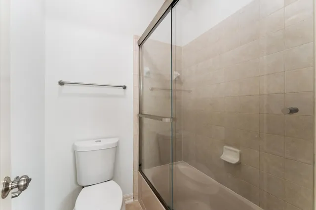 a bathroom with a toilet and shower