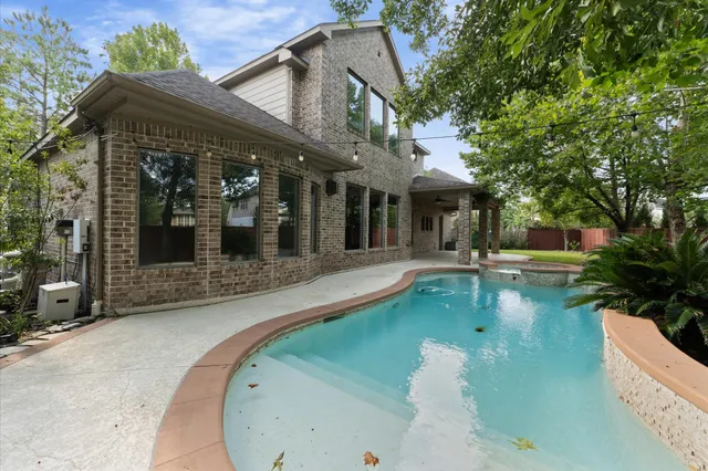 swimming pool view with a garden space