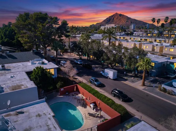 a view of a house with a swimming pool patio and outdoor seating