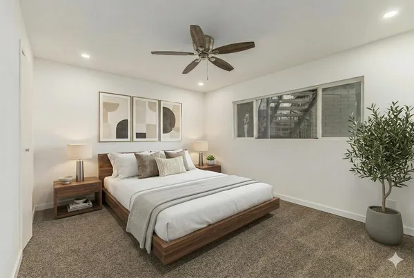 a bedroom with a bed and a potted plant