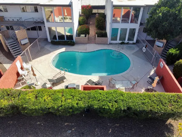 an aerial view of a house with garden space and street view