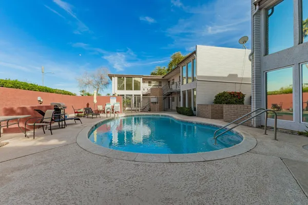 a view of a swimming pool with outdoor seating