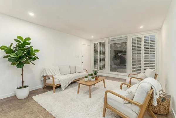 a living room with furniture and a potted plant