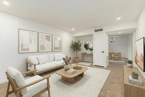 a living room with furniture and a wooden floor
