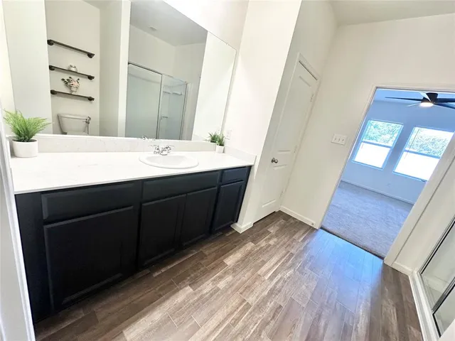 an empty room with closet and a ceiling fan