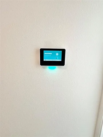 a view of an empty room and kitchen view