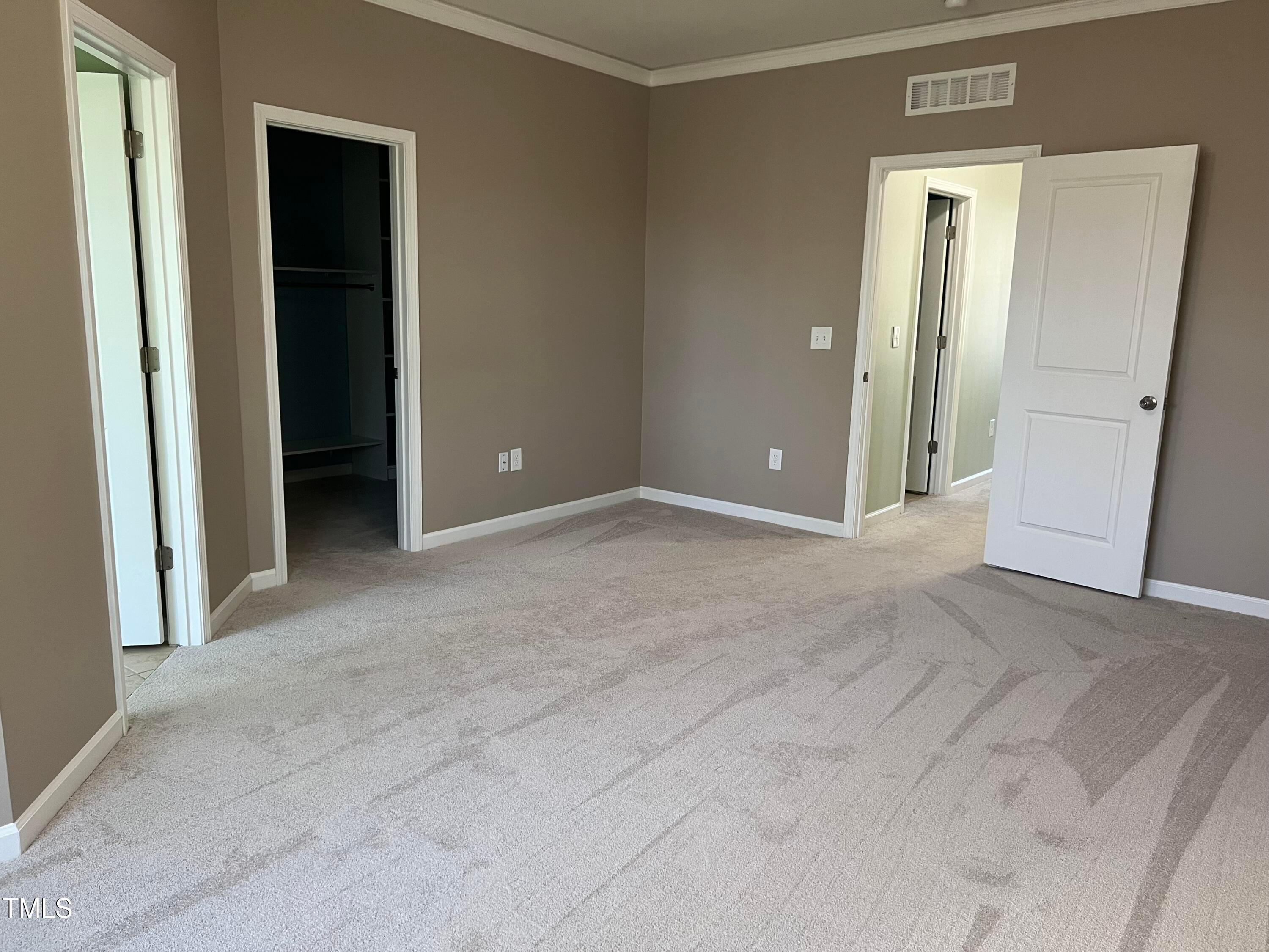 714 Treviso Lane Apex, NC 27502 - Photo 20 of 27 an empty room with closet and a bathroom