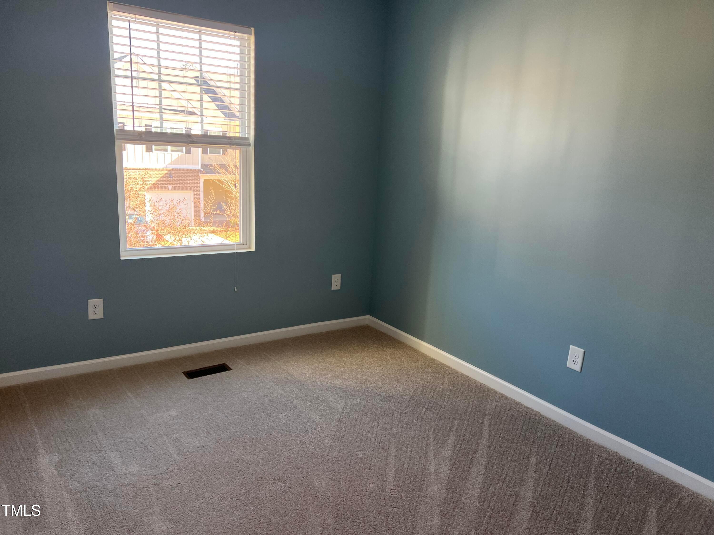 714 Treviso Lane Apex, NC 27502 - Photo 23 of 27 an empty room with a window