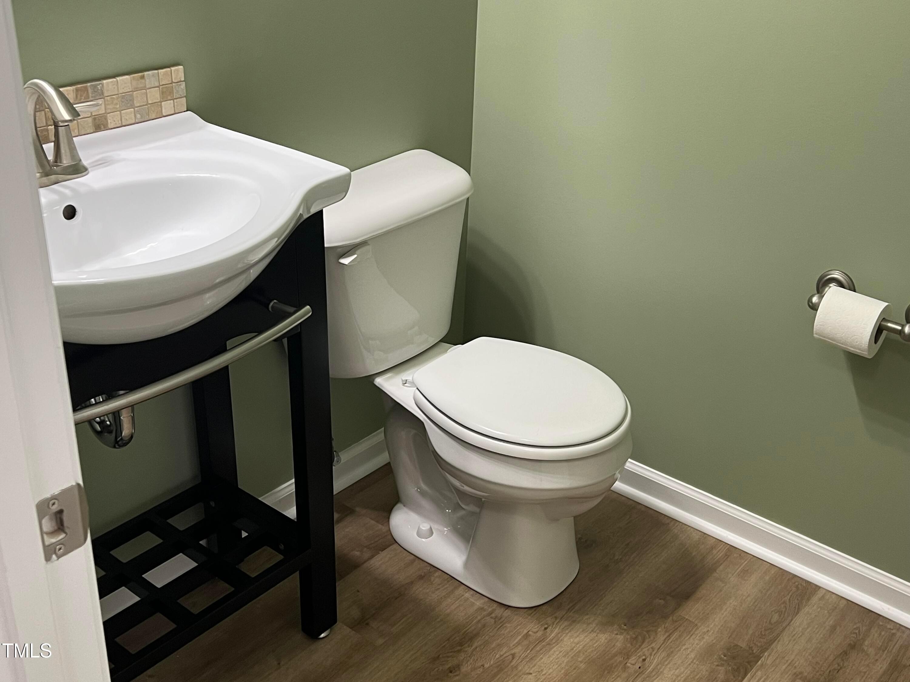 714 Treviso Lane Apex, NC 27502 - Photo 5 of 27 a white toilet sitting next to a bathroom sink