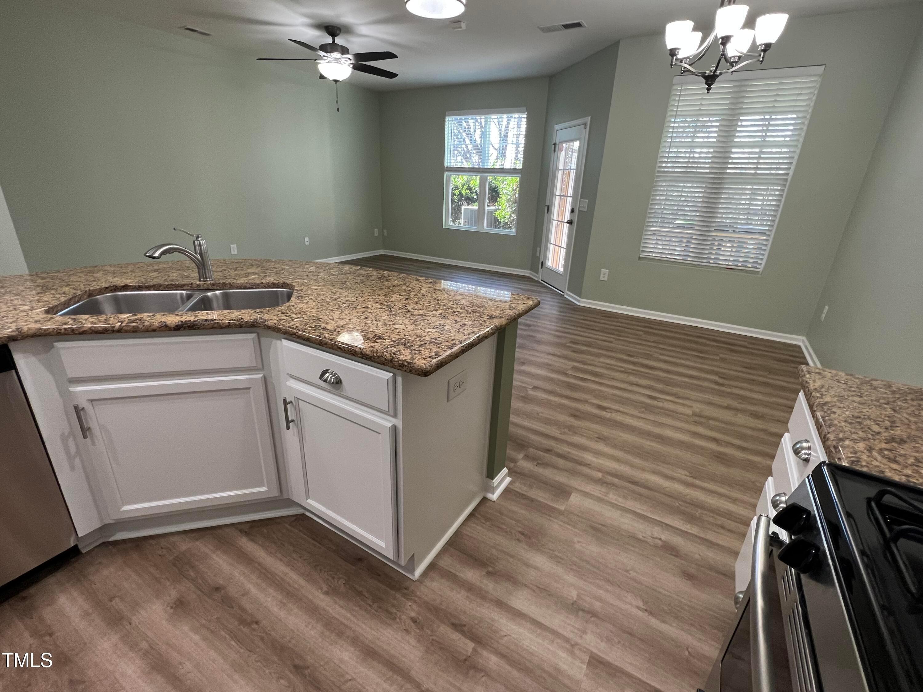 714 Treviso Lane Apex, NC 27502 - Photo 8 of 27 a view of kitchen with granite countertop cabinets a sink and dishwasher