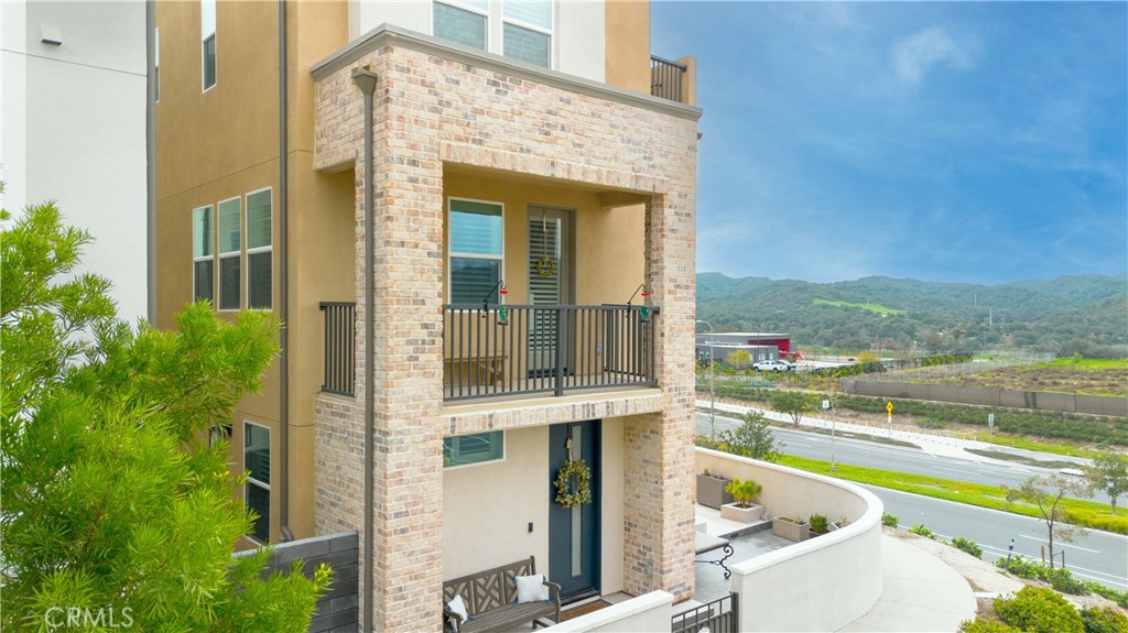 a view of a balcony with a floor to ceiling window and outdoor kitchen