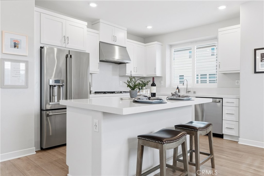 75 Gander Court Rancho Mission Viejo, CA 92694 - Photo 4 of 75 a kitchen with stainless steel appliances a sink and a refrigerator