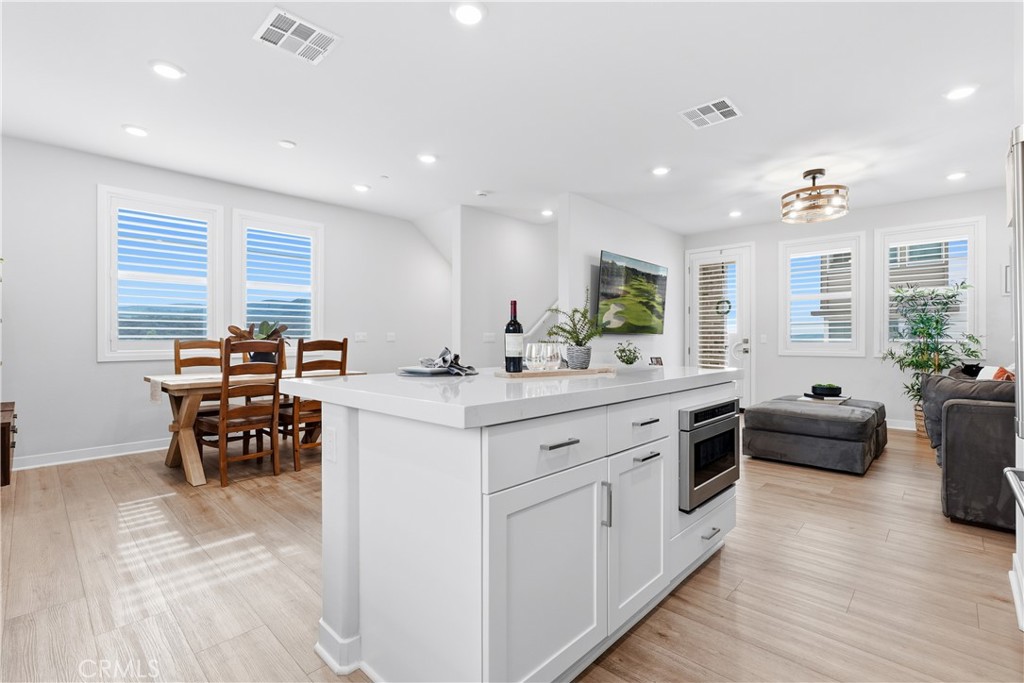 75 Gander Court Rancho Mission Viejo, CA 92694 - Photo 6 of 75 a large white kitchen with stainless steel appliances kitchen island granite countertop a large counter top couches and couches
