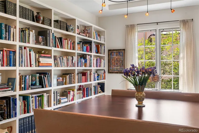 a view of room with lots of book shelves