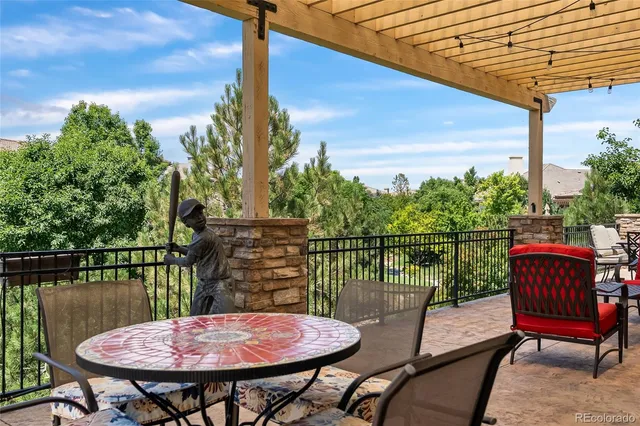 a backyard of a house with a table and chairs