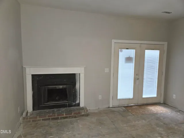 an empty room with fireplace