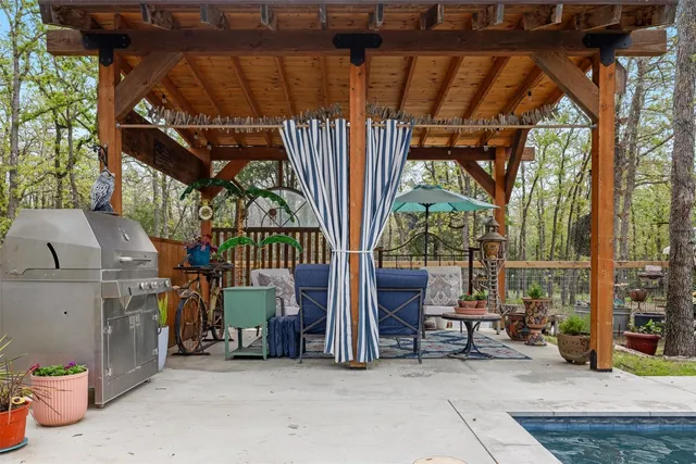 a view of patio with a table and chairs and potted plants