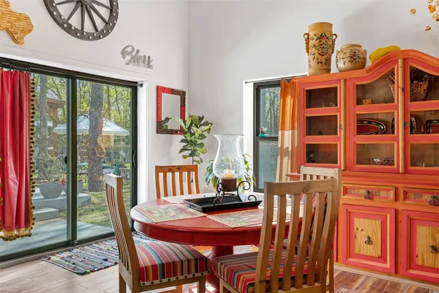 a dining room with furniture a flat screen tv and a large window
