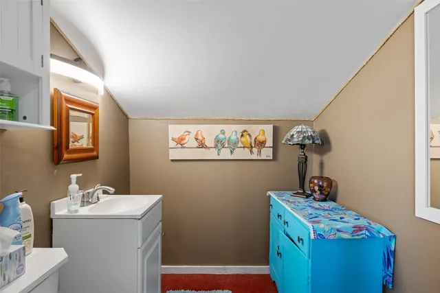 a bathroom with a sink a mirror and a window