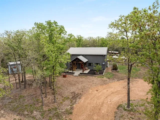 a view of a house with a backyard and sitting area