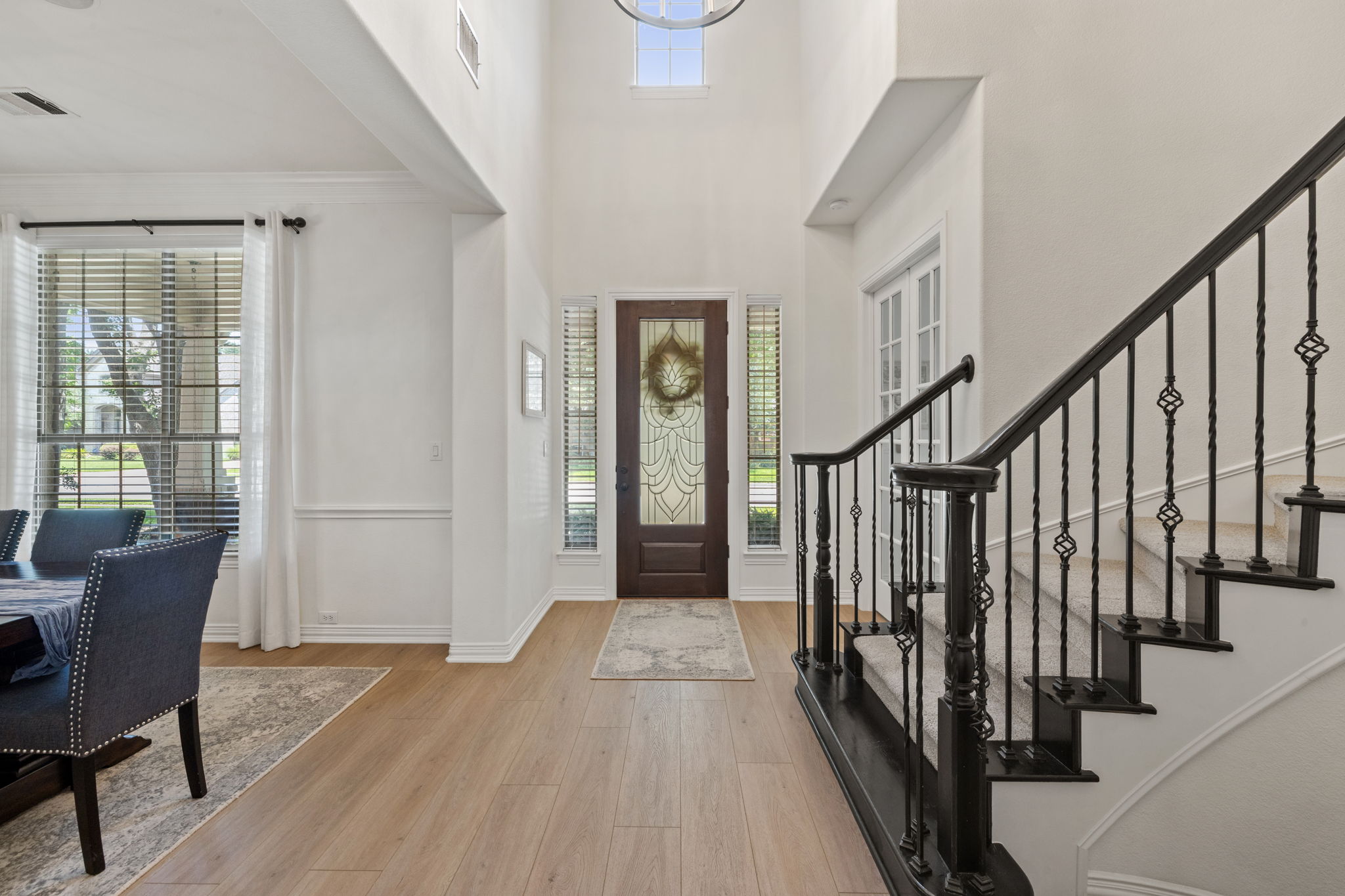 1124 Castle Path Round Rock, TX 78681 - Photo 7 of 40 Enter into a soaring, naturally illuminated foyer featuring exquisite hardwood flooring and an elegant staircase.
